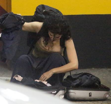 A atriz arruma mala no estacionamento. (Foto: Reprodução)